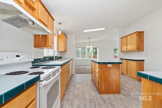 1404 River Run Ln, Caldwell, ID 83605 - kitchen featuring electric stove, under cabinet range hood, a center island, vaulted ceiling, and tile counters