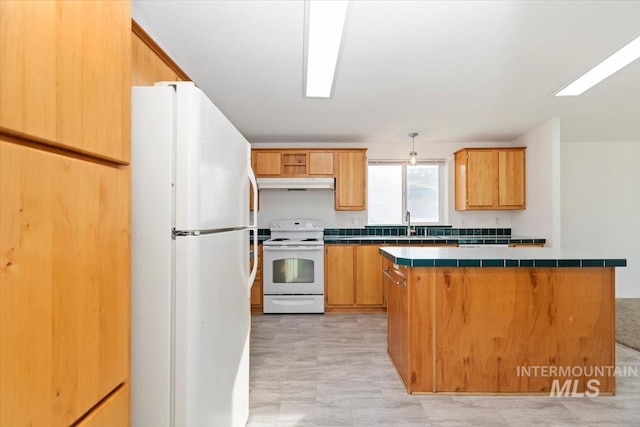1404 River Run Ln, Caldwell, ID 83605 - kitchen featuring white appliances, under cabinet range hood, tile countertops, and a kitchen island