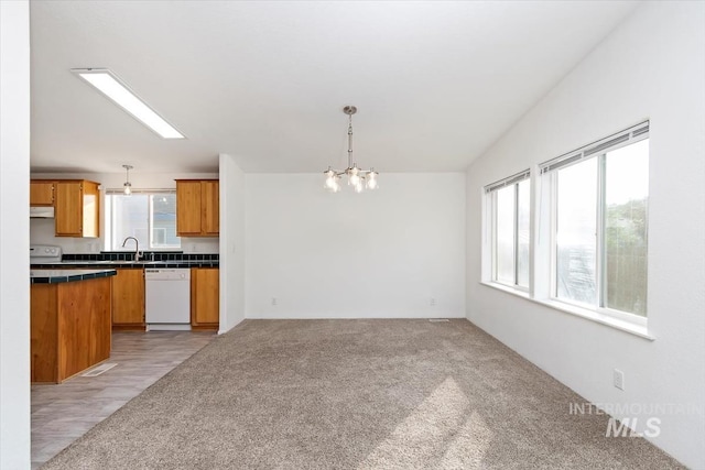 1404 River Run Ln, Caldwell, ID 83605 - kitchen featuring dishwasher, a chandelier, exhaust hood, and pendant lighting