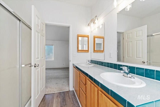 1404 River Run Ln, Caldwell, ID 83605 - bathroom with double vanity, wood finished floors, and an enclosed shower