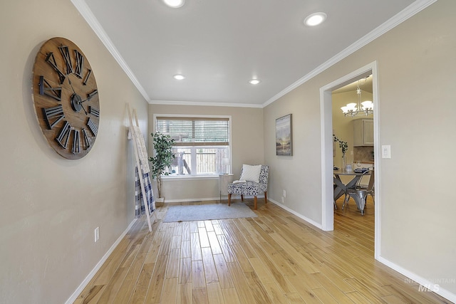 sitting room with baseboards, light wood finished floors, recessed lighting, a chandelier, and crown molding