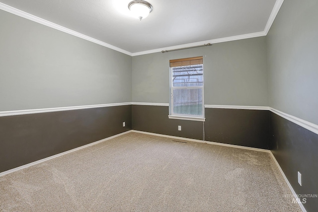 unfurnished room featuring carpet floors, ornamental molding, and baseboards