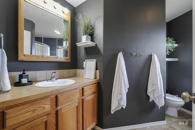 bathroom with toilet, tile patterned floors, and vanity