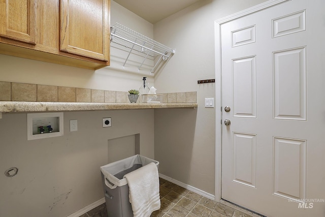 washroom featuring hookup for a washing machine, cabinet space, electric dryer hookup, and baseboards