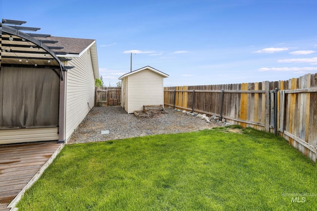 view of yard featuring a storage unit and an outbuilding
