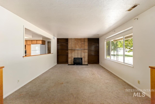 unfurnished living room featuring light colored carpet, baseboards, and a brick fireplace