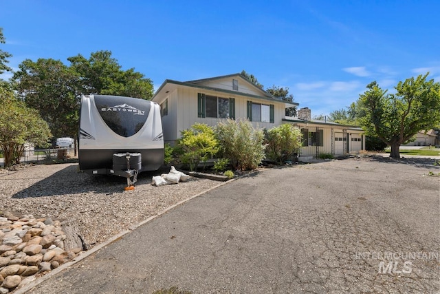 view of front of house featuring an attached garage and asphalt driveway