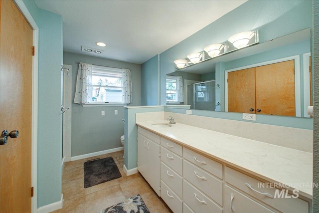 bathroom with toilet, baseboards, tile patterned flooring, a shower stall, and vanity