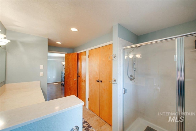 full bath featuring recessed lighting and a stall shower