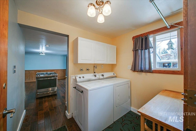 washroom featuring dark wood-style floors, baseboards, a notable chandelier, separate washer and dryer, and cabinet space