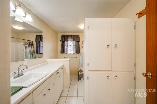 bathroom with a shower with curtain, vanity, and tile patterned flooring
