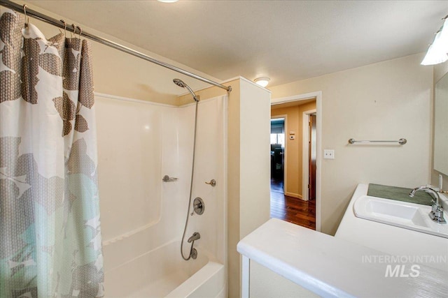 full bathroom featuring wood finished floors, shower / tub combo with curtain, and vanity