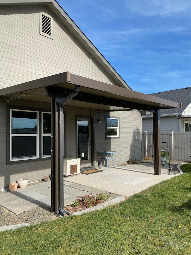 back of house featuring a yard and a patio