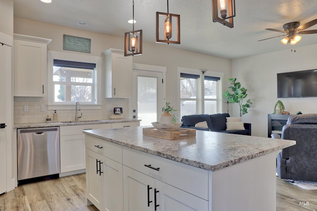 kitchen featuring dishwasher, white cabinetry, and sink