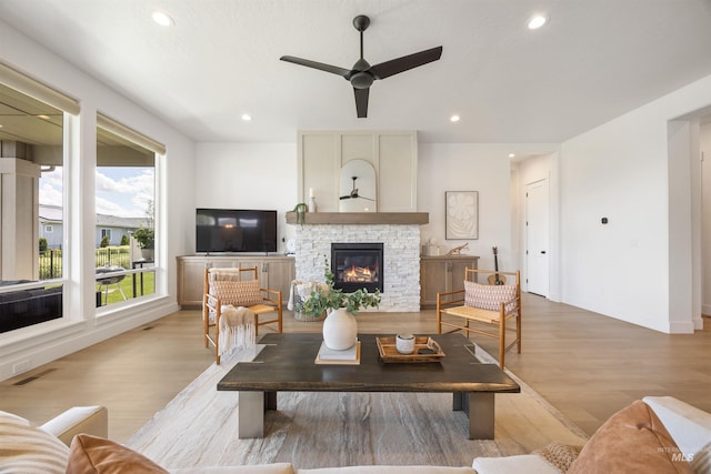5222 S Montague Way, Meridian, ID 83642 - living room featuring ceiling fan, light wood-type flooring, recessed lighting, a stone fireplace, and baseboards