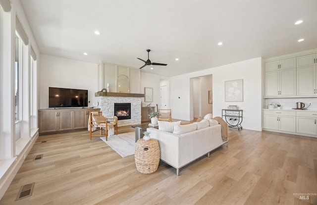 5222 S Montague Way, Meridian, ID 83642 - living room with ceiling fan, light wood-type flooring, a stone fireplace, and recessed lighting