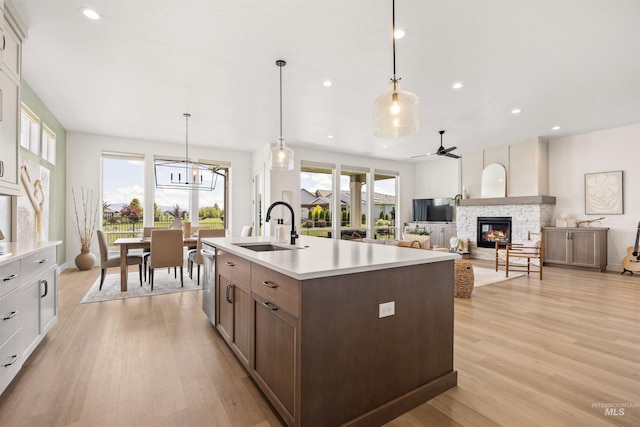 5222 S Montague Way, Meridian, ID 83642 - kitchen with a sink, light countertops, a stone fireplace, light wood finished floors, and recessed lighting