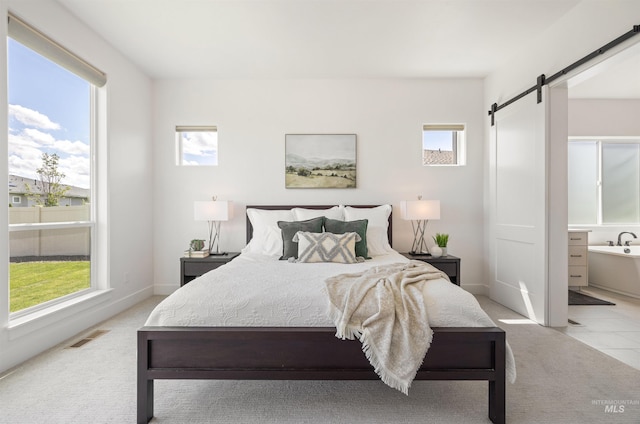 5222 S Montague Way, Meridian, ID 83642 - bedroom featuring a barn door, carpet flooring, and ensuite bath