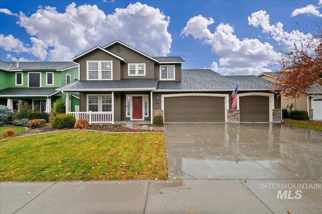 view of front of property with a porch, a garage, and a front yard