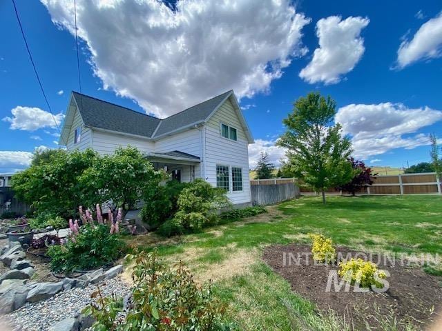 view of side of property with a yard