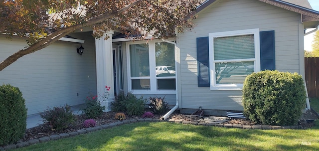 view of side of property with a lawn