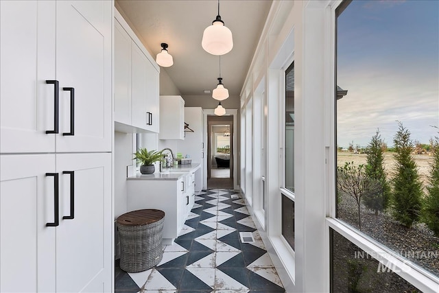hall with a sink and visible vents