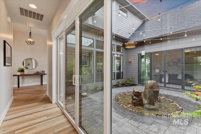 entryway with visible vents, french doors, baseboards, and wood finished floors