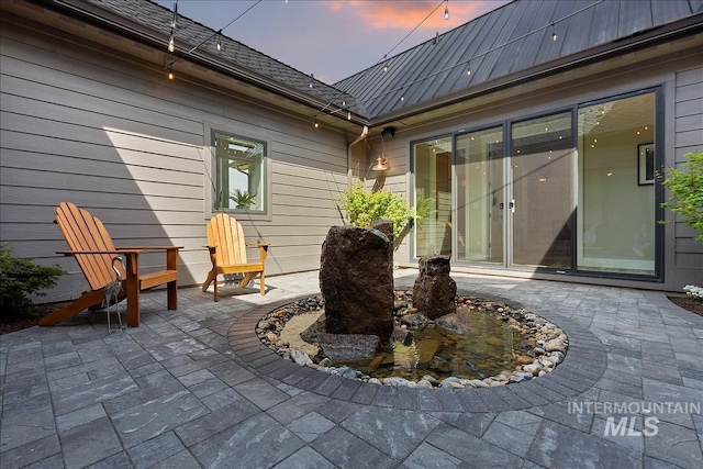 view of patio terrace at dusk
