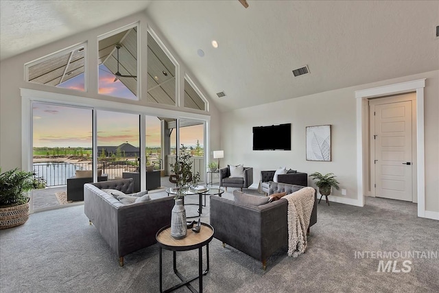 living room with high vaulted ceiling, a wealth of natural light, carpet, and baseboards