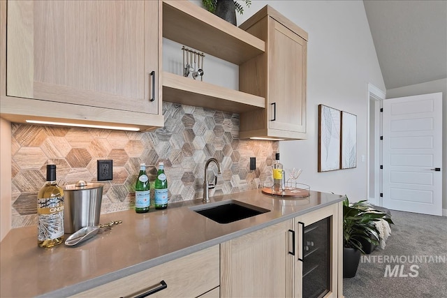 kitchen featuring open shelves, light countertops, a sink, wine cooler, and decorative backsplash