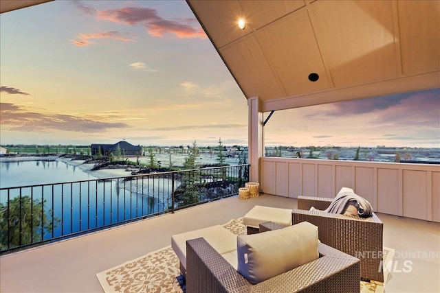 balcony with a water view and outdoor lounge area