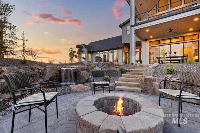 view of patio featuring a fire pit and a balcony