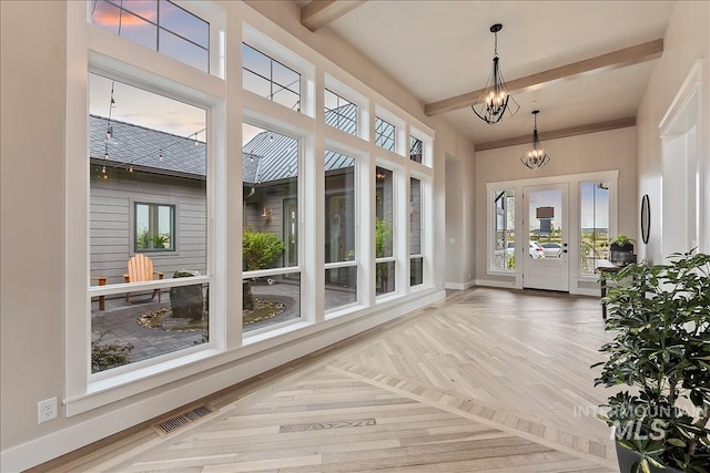 unfurnished sunroom with a chandelier, beam ceiling, and visible vents