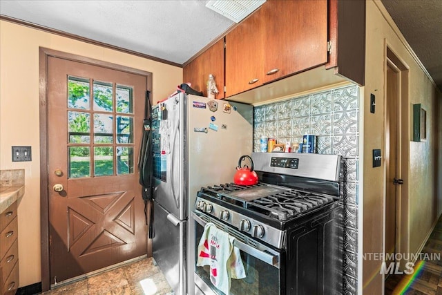 kitchen with light countertops, brown cabinetry, stainless steel appliances, backsplash, and ornamental molding