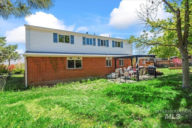 back of property featuring a patio, a pergola, brick siding, and a fenced backyard