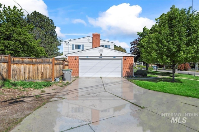 view of property exterior with fence, concrete driveway, a garage, and brick siding