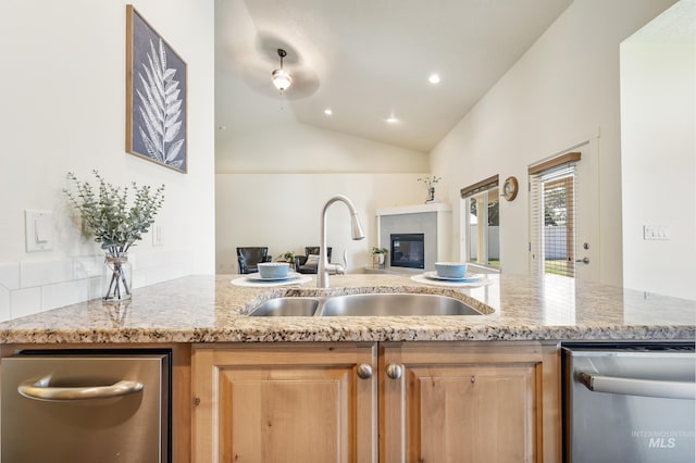 8235 W Tether St, Boise, ID 83709 - kitchen featuring dishwasher, a sink, open floor plan, lofted ceiling, and light stone counters