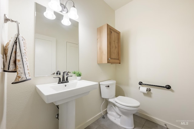8235 W Tether St, Boise, ID 83709 - half bathroom featuring baseboards, tile patterned flooring, and toilet