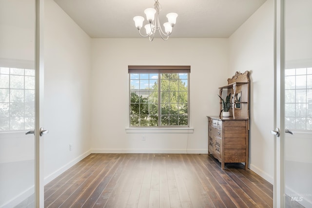 8235 W Tether St, Boise, ID 83709 - unfurnished room featuring a chandelier, dark wood-style flooring, baseboards, and french doors