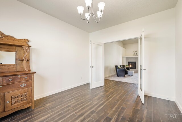 8235 W Tether St, Boise, ID 83709 - interior space with dark wood finished floors, baseboards, a chandelier, and a fireplace