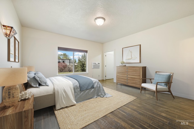 8235 W Tether St, Boise, ID 83709 - bedroom with wood finished floors, a wall mounted AC, baseboards, and a textured ceiling