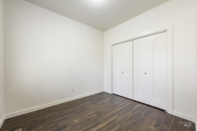 8235 W Tether St, Boise, ID 83709 - unfurnished bedroom with dark wood-type flooring, baseboards, and a closet