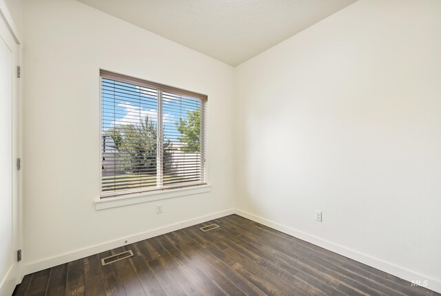 8235 W Tether St, Boise, ID 83709 - unfurnished room with baseboards and dark wood finished floors