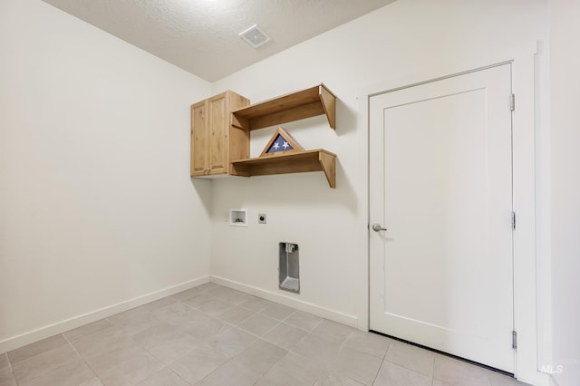 8235 W Tether St, Boise, ID 83709 - washroom with hookup for a washing machine, electric dryer hookup, baseboards, a textured ceiling, and cabinet space