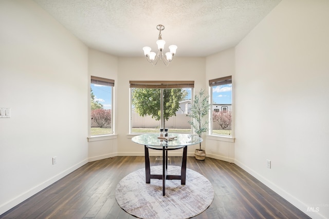 8235 W Tether St, Boise, ID 83709 - dining space featuring a chandelier, dark wood-style flooring, baseboards, and a textured ceiling