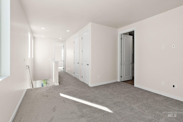 interior space featuring recessed lighting, carpet flooring, an upstairs landing, and baseboards