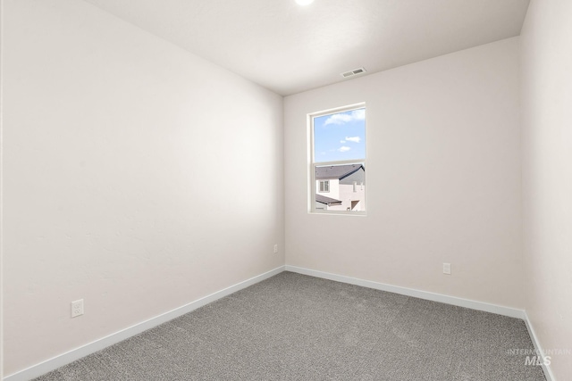 unfurnished room with baseboards, visible vents, and carpet floors