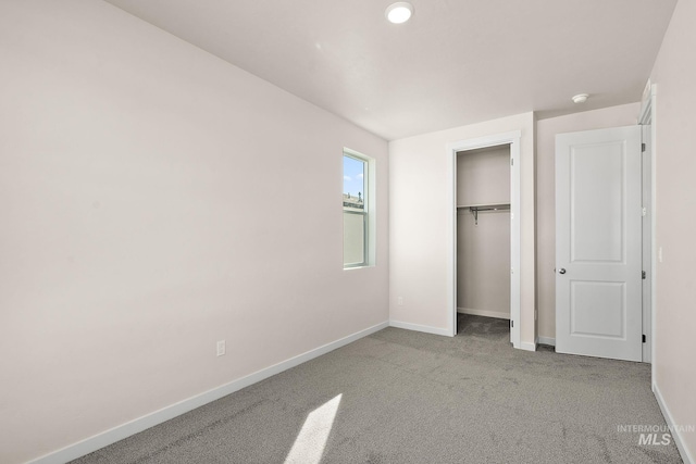 unfurnished bedroom with a closet, baseboards, and carpet floors