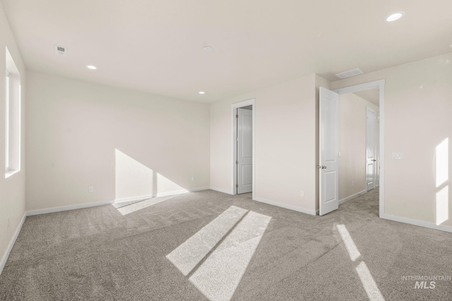 unfurnished bedroom featuring recessed lighting, visible vents, baseboards, and light colored carpet