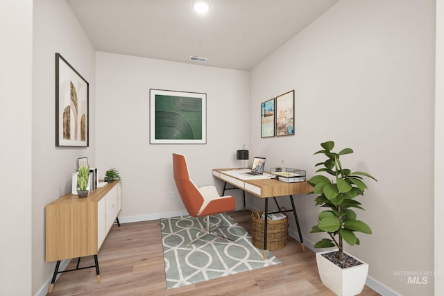 home office featuring visible vents, wood finished floors, and baseboards